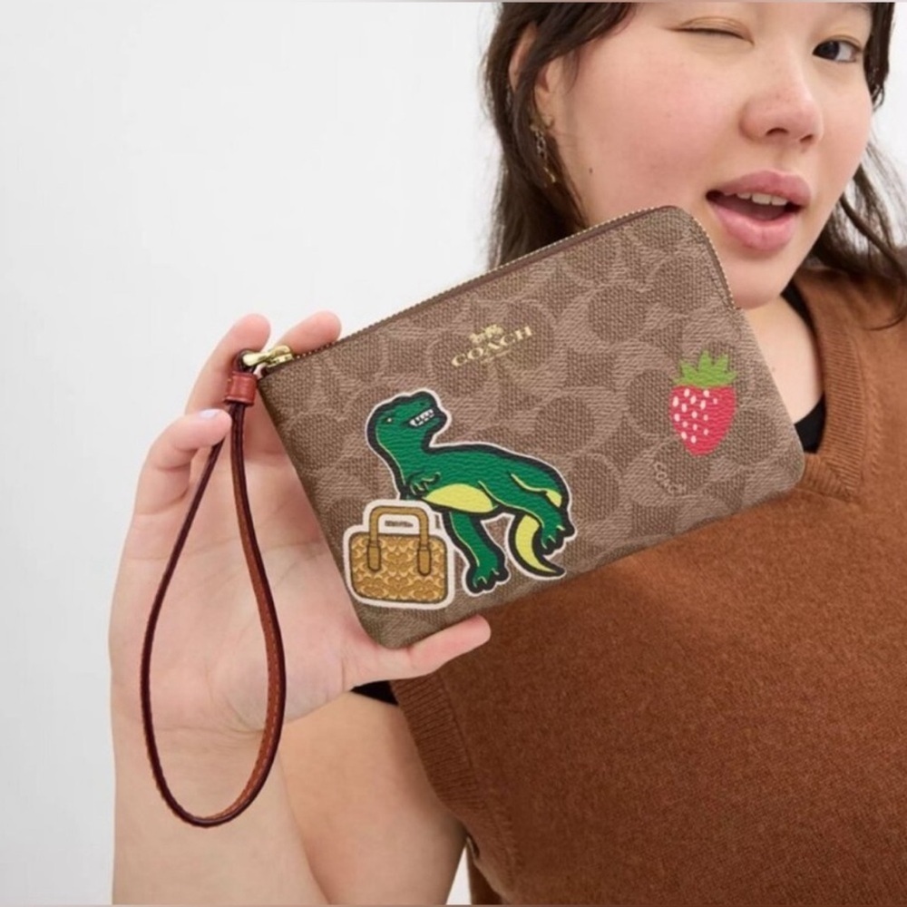 Coach Corner Zip Wristlet In Signature Canvas With Sticker Print Dinosaur